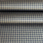 a sheet of Japanese chiyogami paper with a check plaid design in grey, black and gold