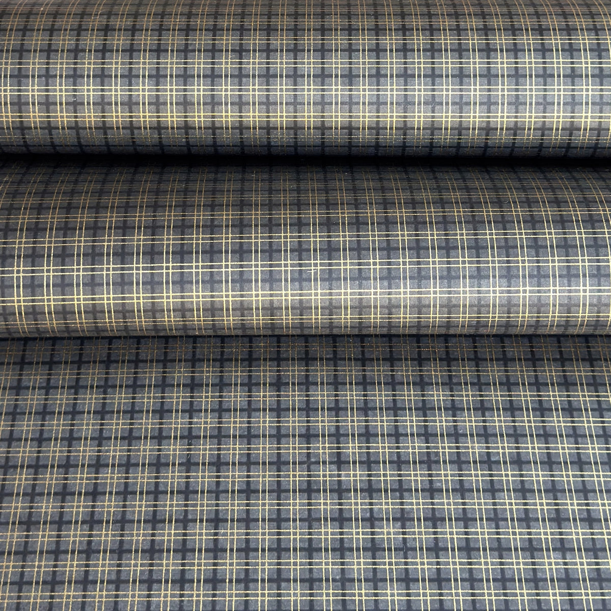 a sheet of Japanese chiyogami paper with a check plaid design in grey, black and gold