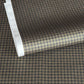 a sheet of Japanese chiyogami paper with a check plaid design in grey, black and gold