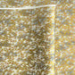 a sheet of Japanese yuzen chiyogami paper with a pattern of a flock of lots of birds flying. Birds are white, gold or copper in colour and flying on a ground of light grey and white sky
