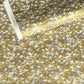 a sheet of Japanese yuzen chiyogami paper with a pattern of a flock of lots of birds flying. Birds are white, gold or copper in colour and flying on a ground of light grey and white sky