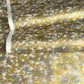 a sheet of Japanese yuzen chiyogami paper with a pattern of a flock of lots of birds flying. Birds are white, gold or copper in colour and flying on a ground of light grey and white sky