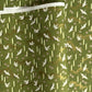 a sheet of Japanese chiyogami paper with an olive green ground and a pattern of white flying cranes and arrows.  There are also little pink cherry blossom flowers and gold clouds.