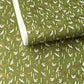 a sheet of Japanese chiyogami paper with an olive green ground and a pattern of white flying cranes and arrows.  There are also little pink cherry blossom flowers and gold clouds.