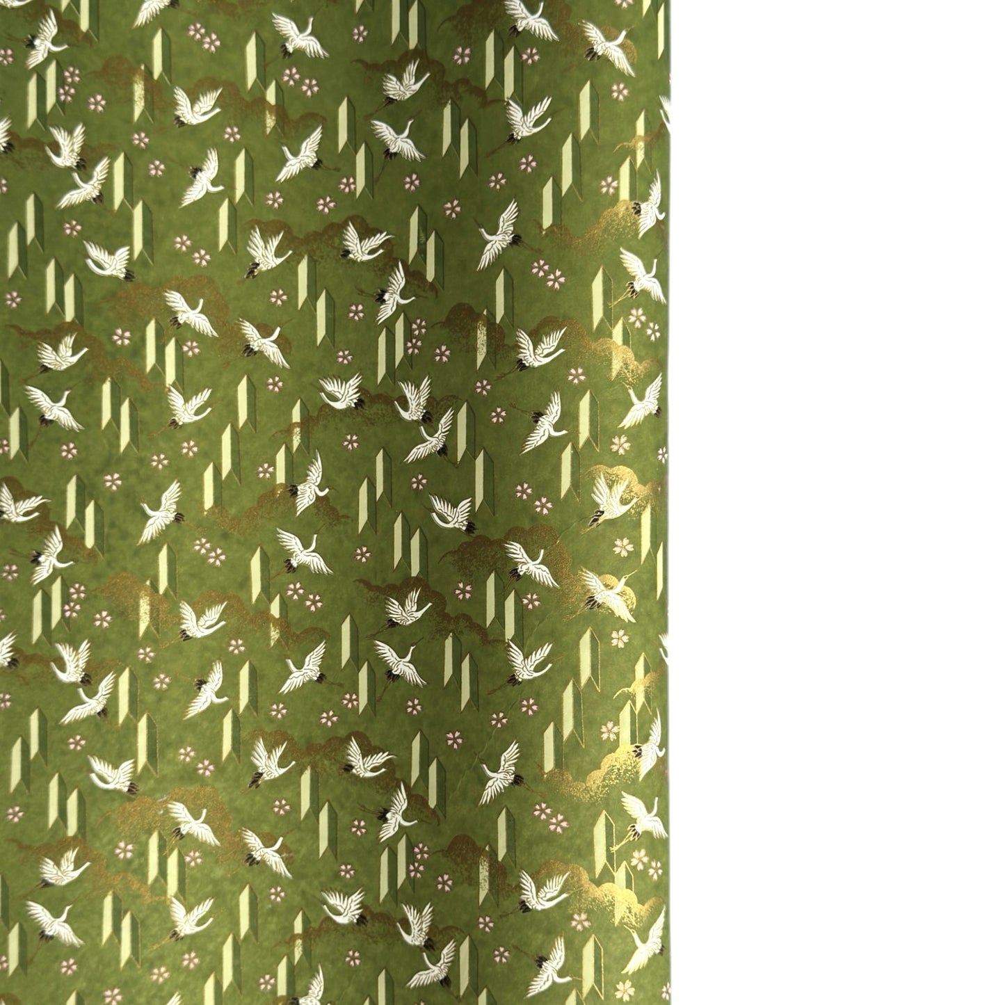 a sheet of Japanese chiyogami paper with an olive green ground and a pattern of white flying cranes and arrows.  There are also little pink cherry blossom flowers and gold clouds.