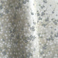 Japanese silkscreen chiyogami paper with a delicate flower design in soft grey on an ivory pearlescent backdrop