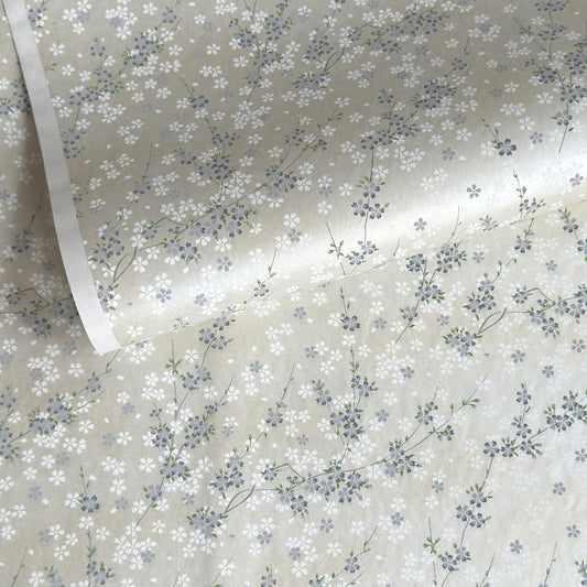 Japanese silkscreen chiyogami paper with a delicate flower design in soft grey on an ivory pearlescent backdrop