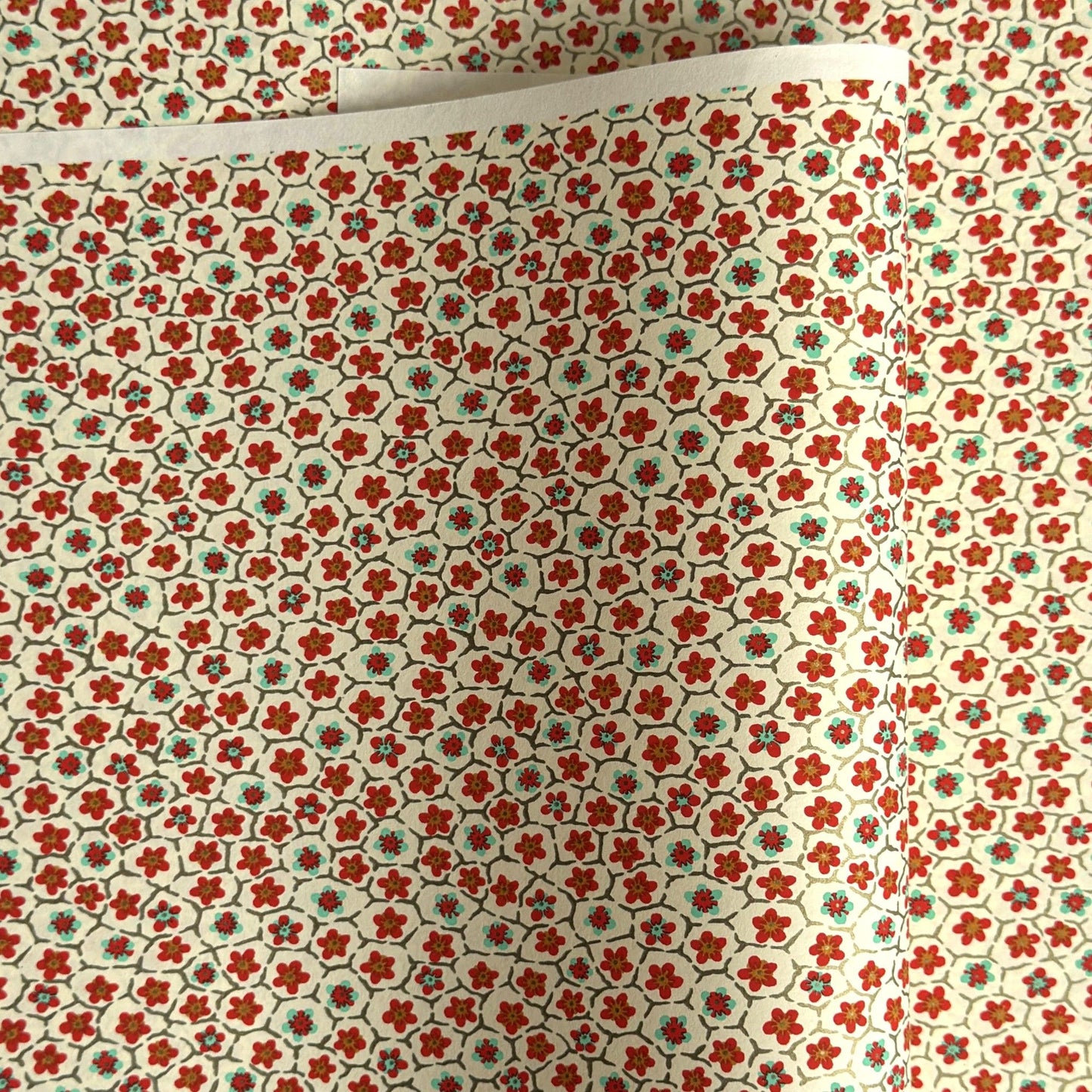 japanese silk-screen handmade paper, chiyogami, with red and aqua plum flowers repeat pattern