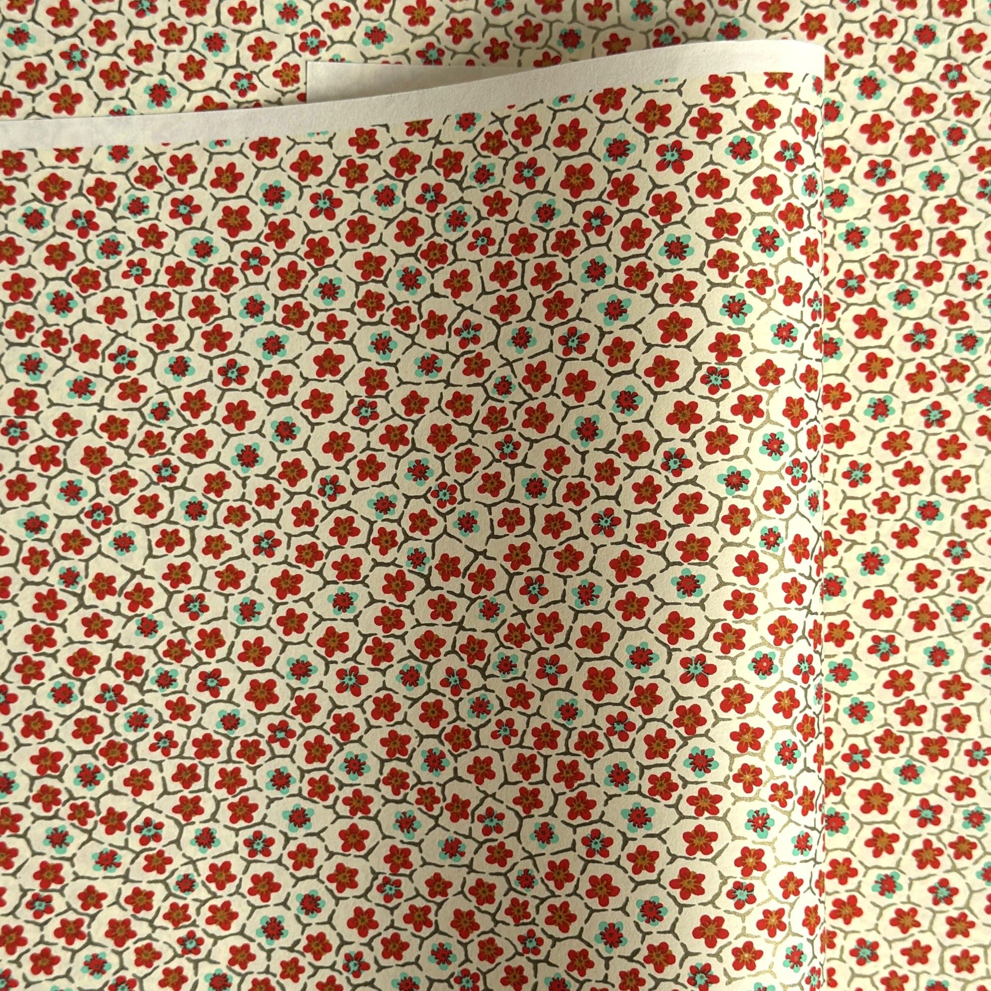 japanese silk-screen handmade paper, chiyogami, with red and aqua plum flowers repeat pattern