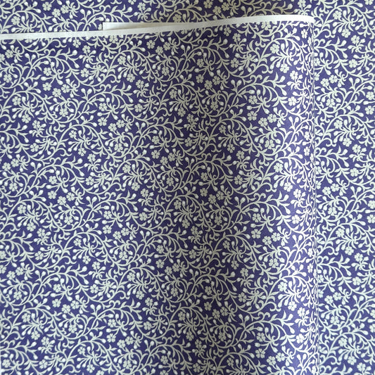 a sheet of Japanese silkscreen printed chiyogami paper with a small floral repeat pattern in grey and white on a periwinkle blue background