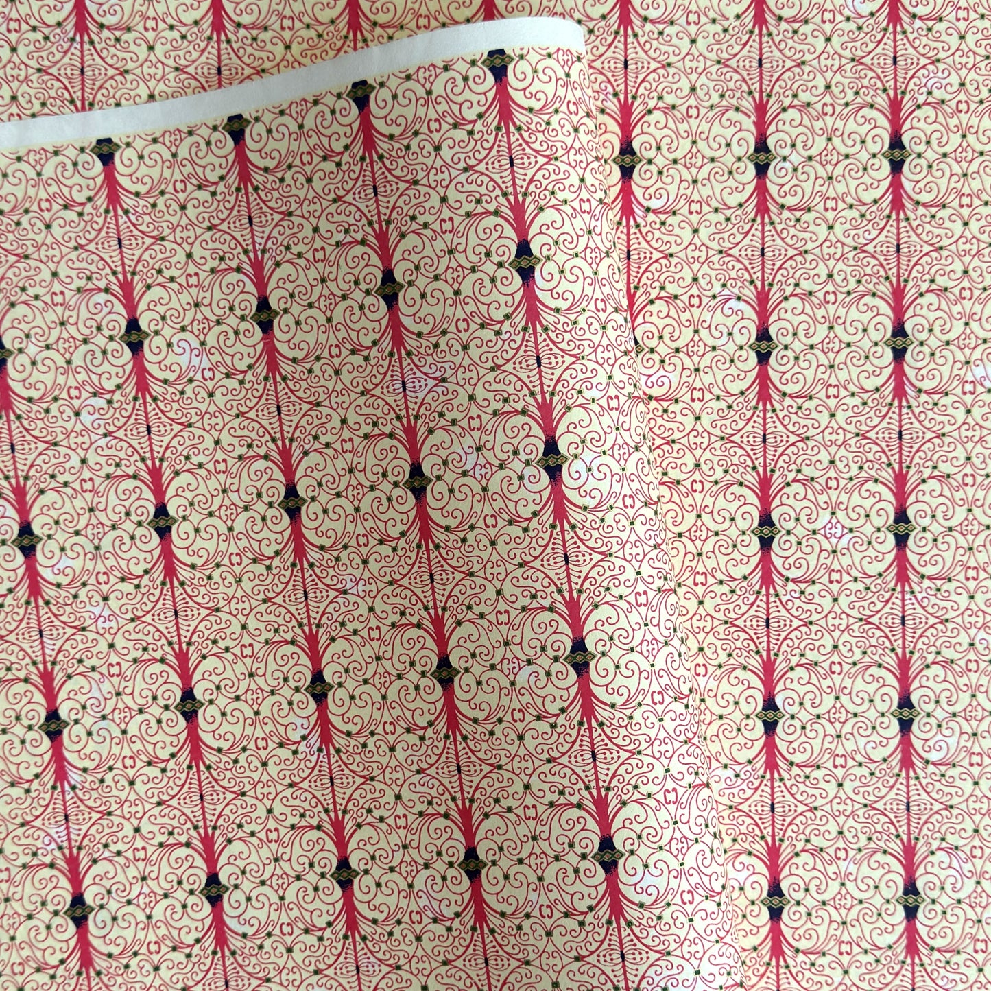 Japanese silkscreen chiyogami paper with a intricate filigree trellis design in pink with gold accent