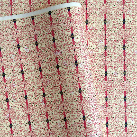 Japanese silkscreen chiyogami paper with a intricate filigree trellis design in pink with gold accent