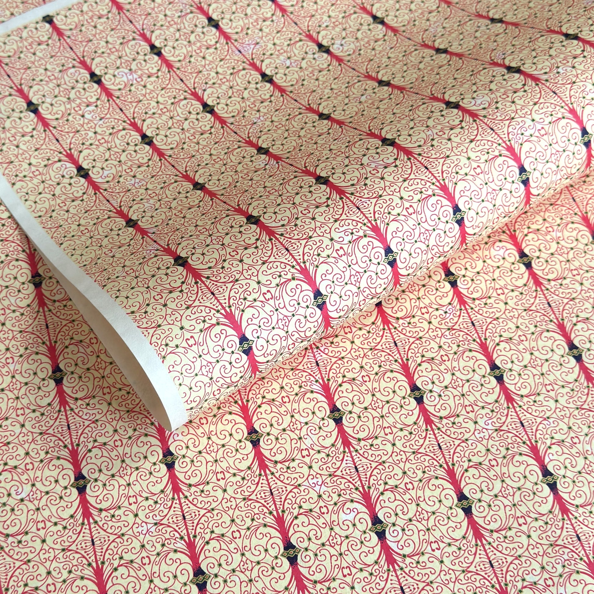 Japanese silkscreen chiyogami paper with a intricate filigree trellis design in pink with gold accent