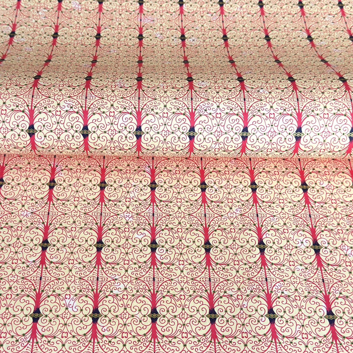 Japanese silkscreen chiyogami paper with a intricate filigree trellis design in pink with gold accent