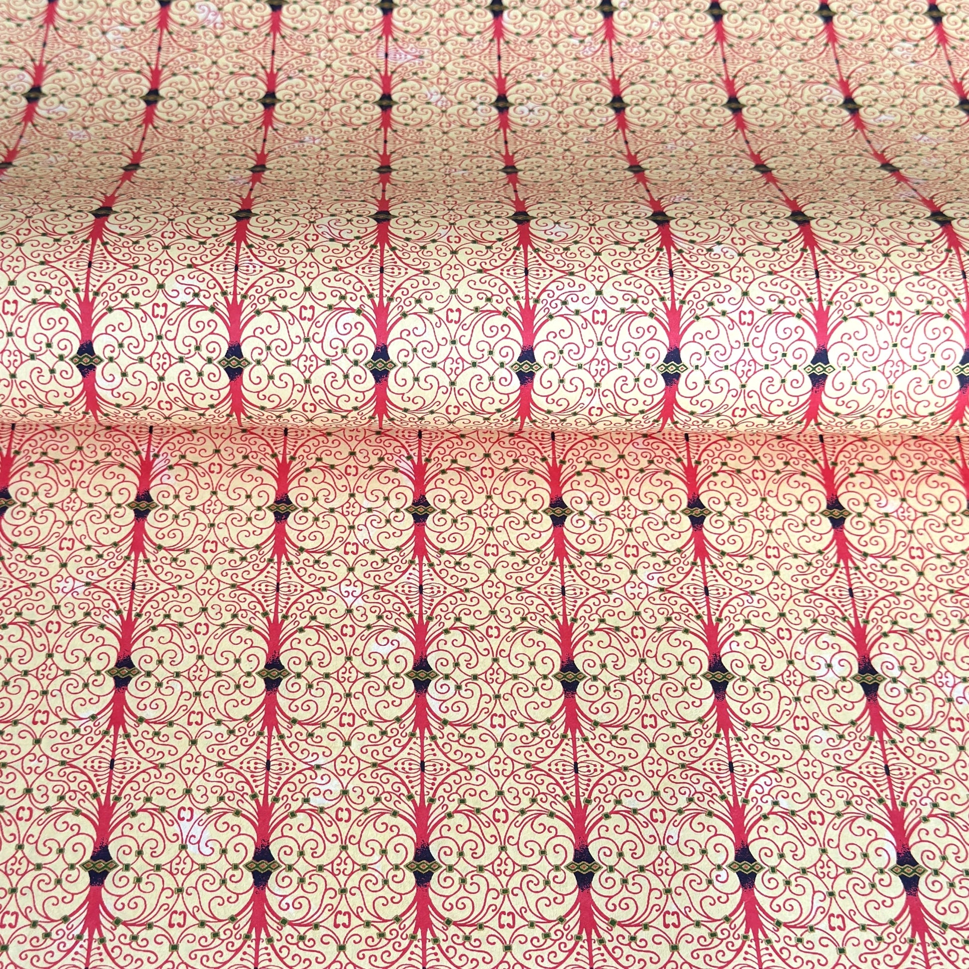 Japanese silkscreen chiyogami paper with a intricate filigree trellis design in pink with gold accent