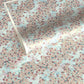 Japanese silkscreen chiyogami paper with an abundance of pale pink cherry blossom with a pale blue backdrop of meandering water, finished with metallic gold ink.
