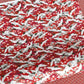 Japanese silkscreen chiyogami paper with a repeat pattern of white cranes in flight on a red and silver background