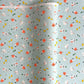 japanese silk-screen handmade paper showing spring animals motifs on a light blue backdrop