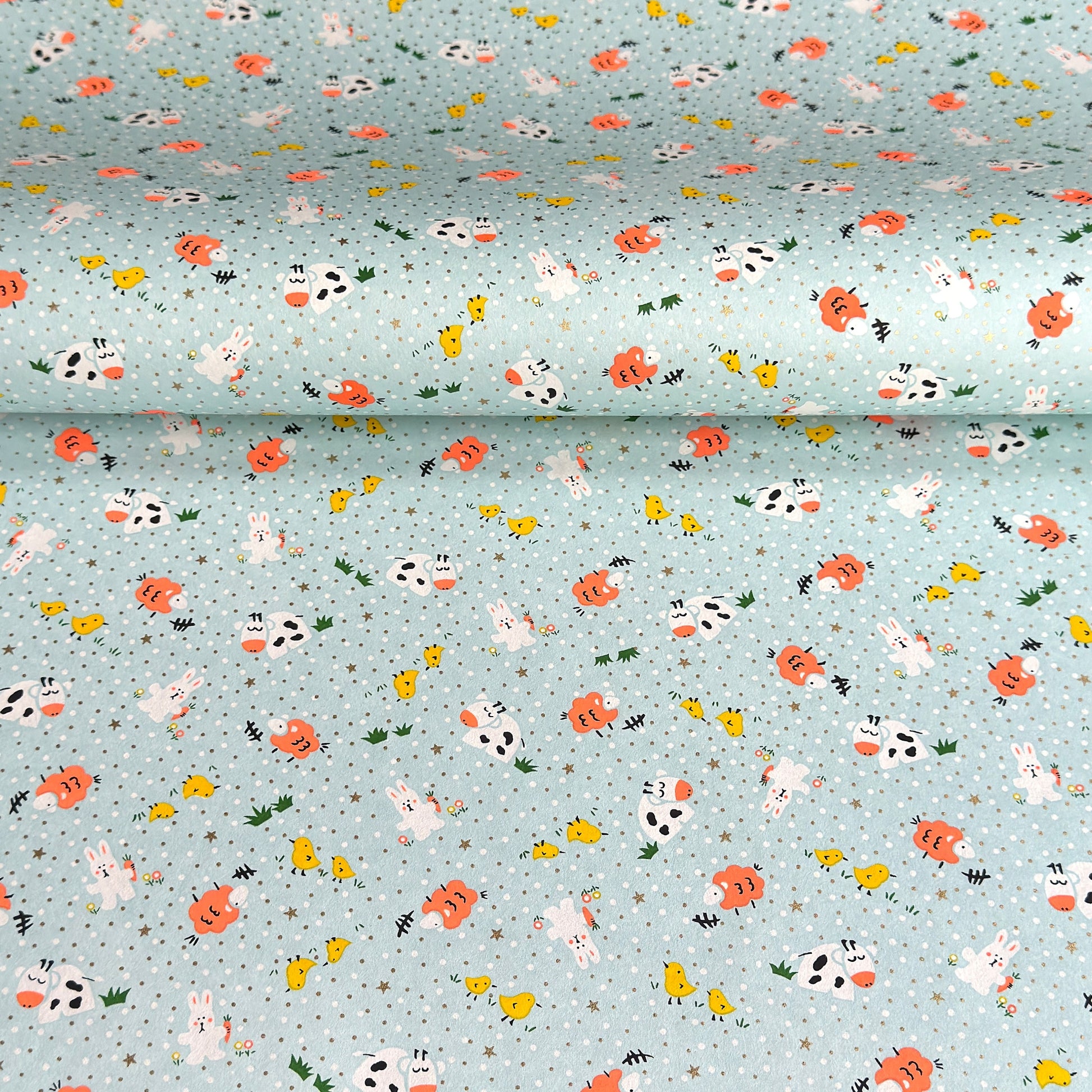 japanese silk-screen handmade paper showing spring animals motifs on a light blue backdrop
