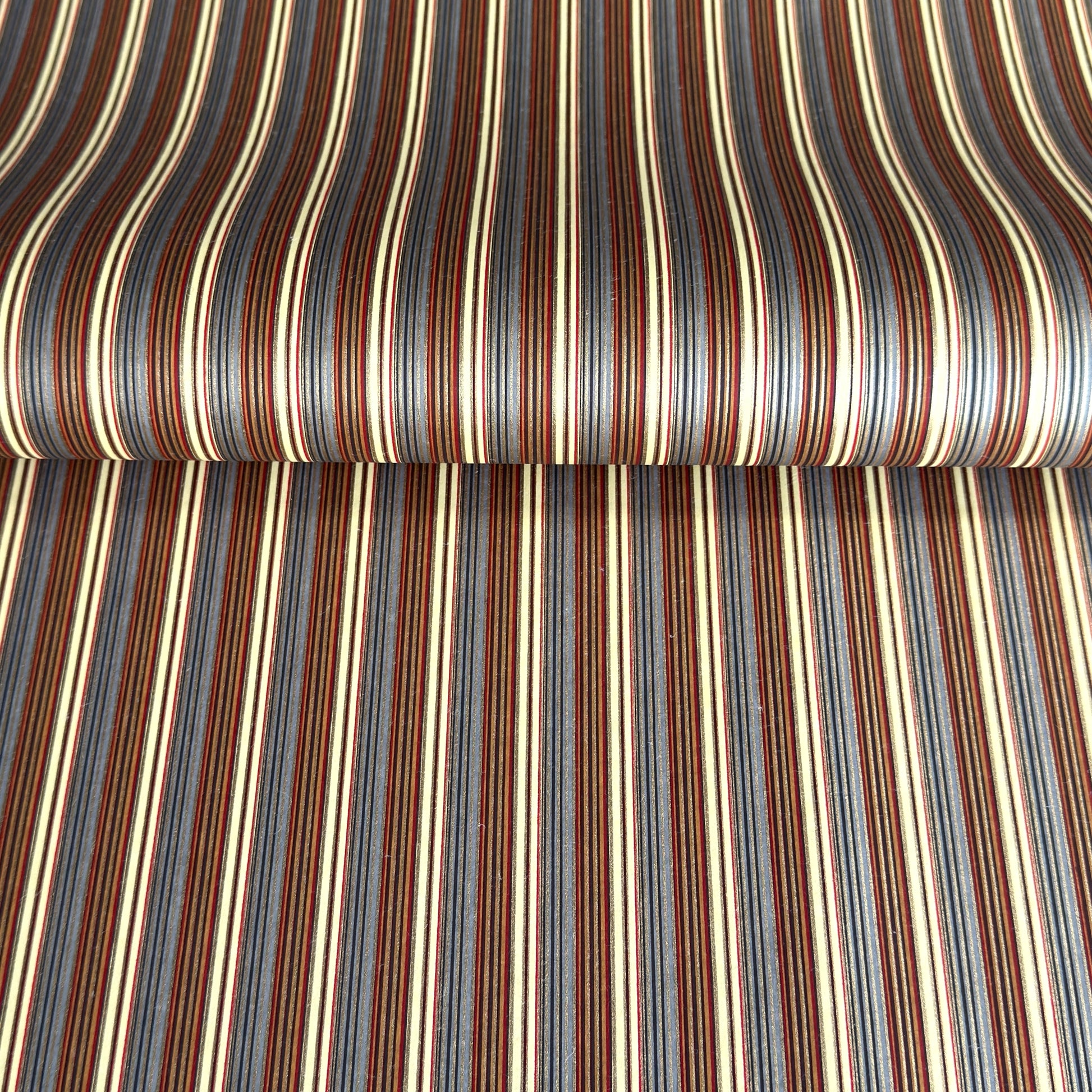 Japanese silkscreen chiyogami paper with a classic narrow stripe pattern in earthy tones of brown, grey, cream, black and gold.