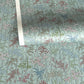 japanese silk-screen handmade paper showing pattern of bamboo, flowers and foliage on light teal backdrop