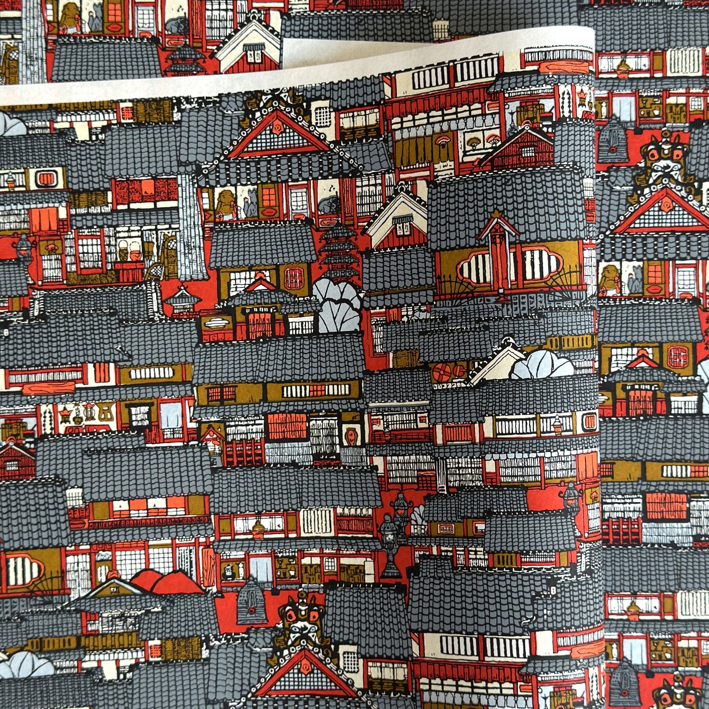 Japanese chiyogami paper (silkscreen printed) with a city landscape in grey, red and orange.