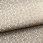 Japanese silkscreen chiyogami paper with a repeat pattern of cherry blossom flowers in taupe and white