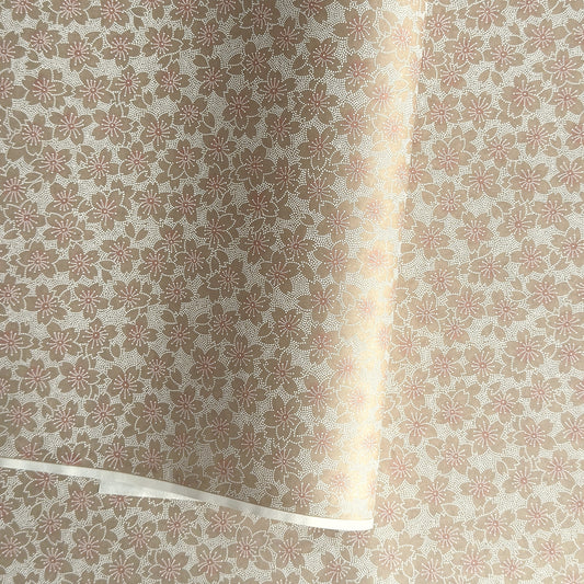 Japanese silkscreen chiyogami paper with a repeat pattern of cherry blossom flowers in taupe and white