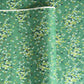 Japanese silkscreen chiyogami paper with a delicate butterfly pattern on a teal backdrop