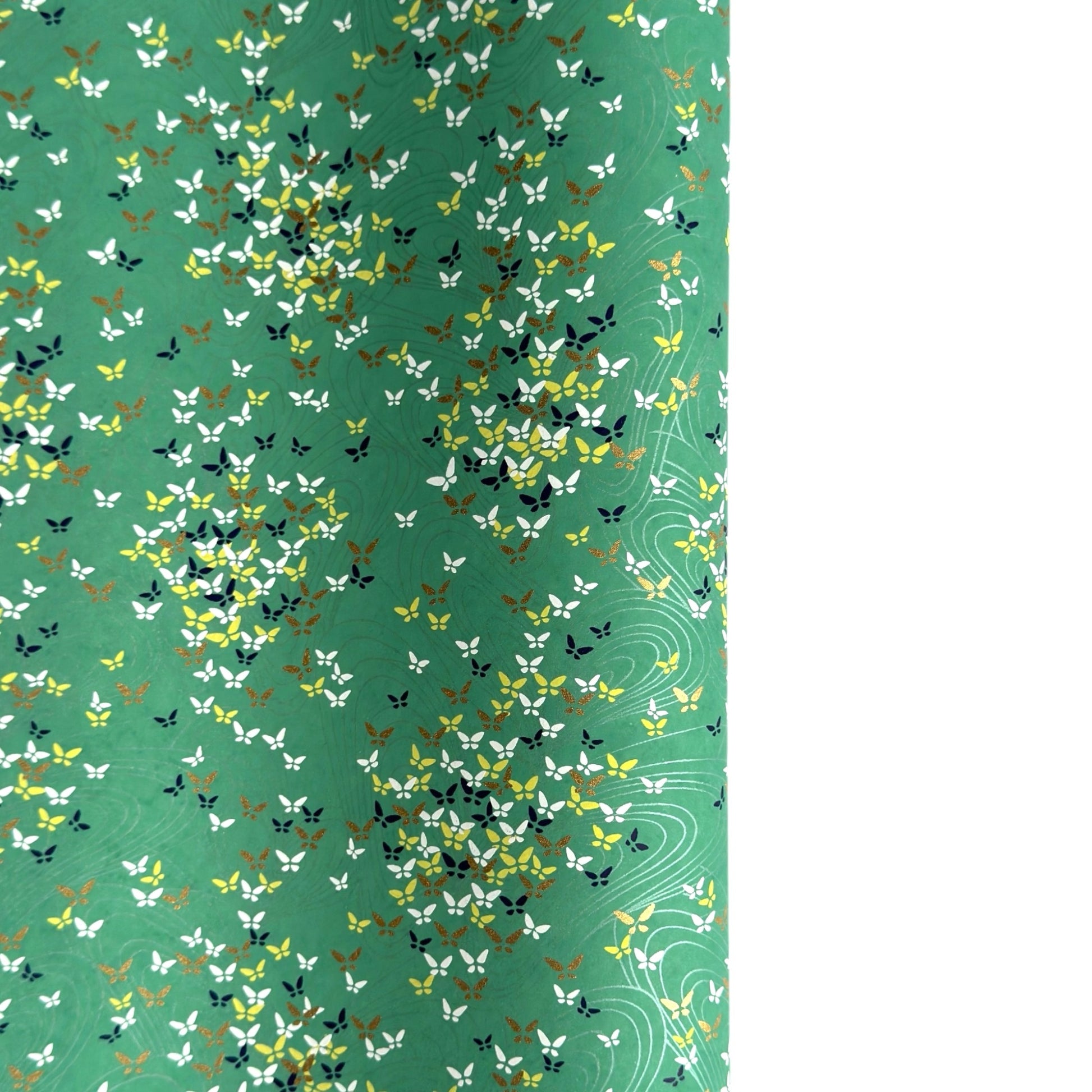 Japanese silkscreen chiyogami paper with a delicate butterfly pattern on a teal backdrop