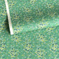 Japanese silkscreen chiyogami paper with a delicate butterfly pattern on a teal backdrop