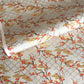 japanese silk-screen handmade paper, chiyogami, showing branches of red cherry blossom and gold clouds on a backdrop of silver, cream and gold