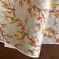 japanese silk-screen handmade paper, chiyogami, showing branches of red cherry blossom and gold clouds on a backdrop of silver, cream and gold