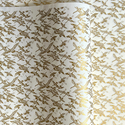 japanese silk-screen handmade paper showing gold cranes in flight on ivory backdrop