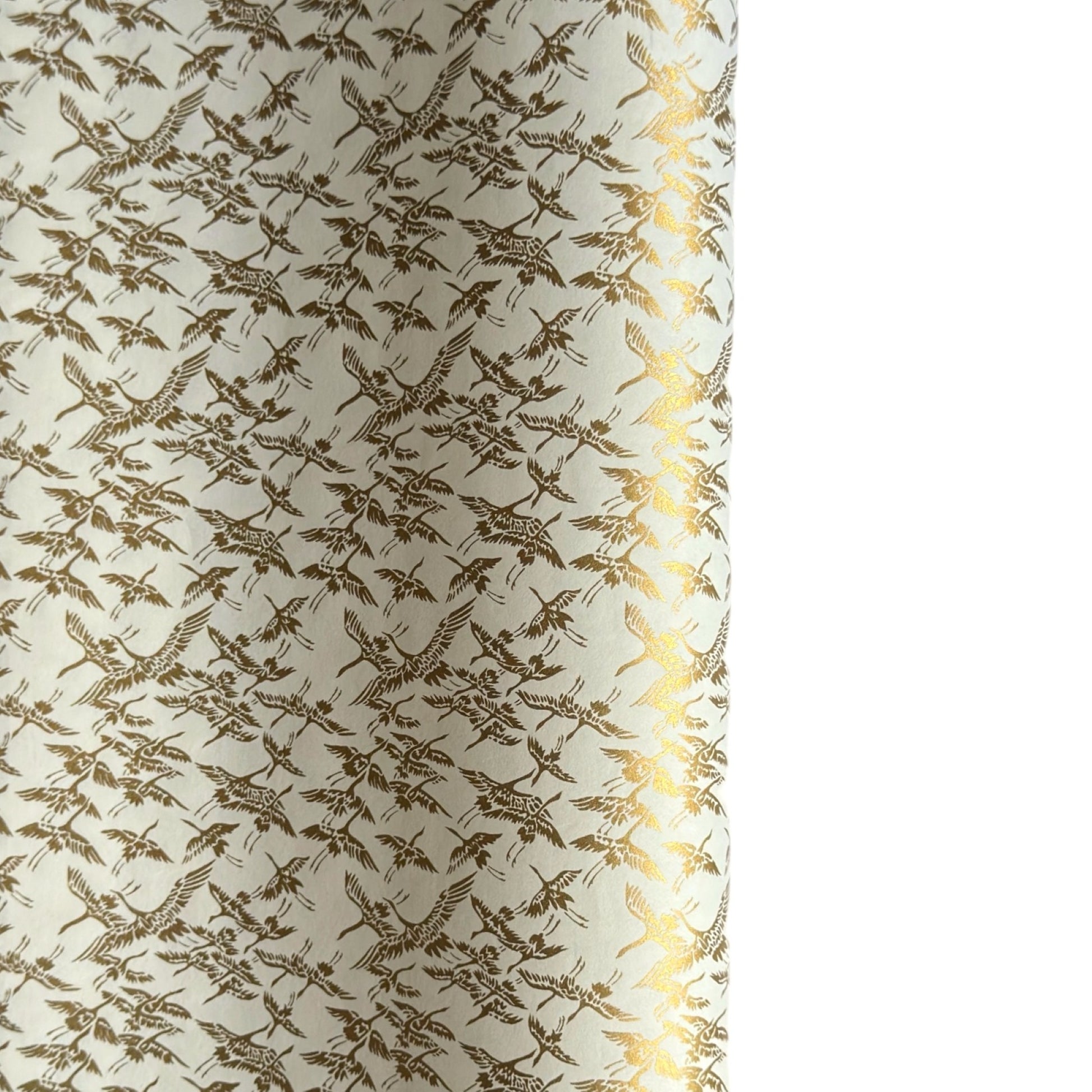 japanese silk-screen handmade paper showing gold cranes in flight on ivory backdrop