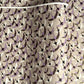 a sheet of Japanese chiyogami yuzen paper with a pattern of cranes in flight in lilac, black, taupe and gold