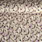 a sheet of Japanese chiyogami yuzen paper with a pattern of cranes in flight in lilac, black, taupe and gold