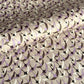 a sheet of Japanese chiyogami yuzen paper with a pattern of cranes in flight in lilac, black, taupe and gold