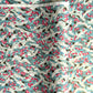 Japanese chiyogami paper with a pattern of white cranes, pink cherry blossom on a blue background. 