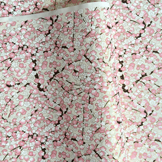 Japanese chiyogami paper with pale pink plum blossom, dark brown branches on an ivory background.