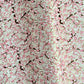 Japanese chiyogami paper with pale pink plum blossom, dark brown branches on an ivory background.