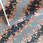 Diagonal branches of rich pink plum (ume) blossom on a midnight blue background with gold accents. Japanese chiyogami paper