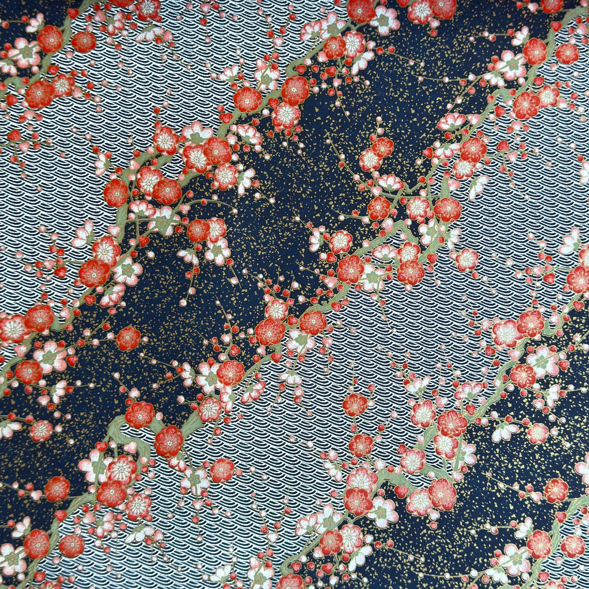 Diagonal branches of rich pink plum (ume) blossom on a midnight blue background with gold accents. Japanese chiyogami paper