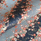 Diagonal branches of rich pink plum (ume) blossom on a midnight blue background with gold accents. Japanese chiyogami paper