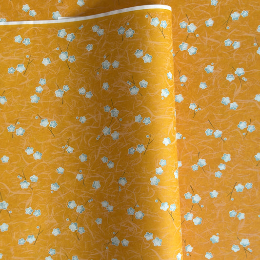 Pale blue plum (ume) blossom with a rich saffron backdrop.  Japanese chiyogami paper.