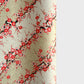 Japanese chiyogami silkscreen paper with diagonal branches of pink plum blossom on a sage green backdrop.