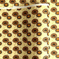 Japanese silkscreen chiyogami paper with a brown and orange umbrella pattern on a buttermilk backdrop 