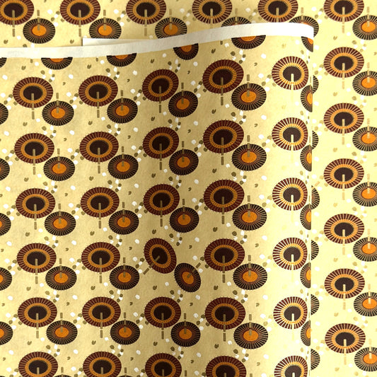Japanese silkscreen chiyogami paper with a brown and orange umbrella pattern on a buttermilk backdrop 
