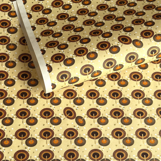 Japanese silkscreen chiyogami paper with a brown and orange umbrella pattern on a buttermilk backdrop 