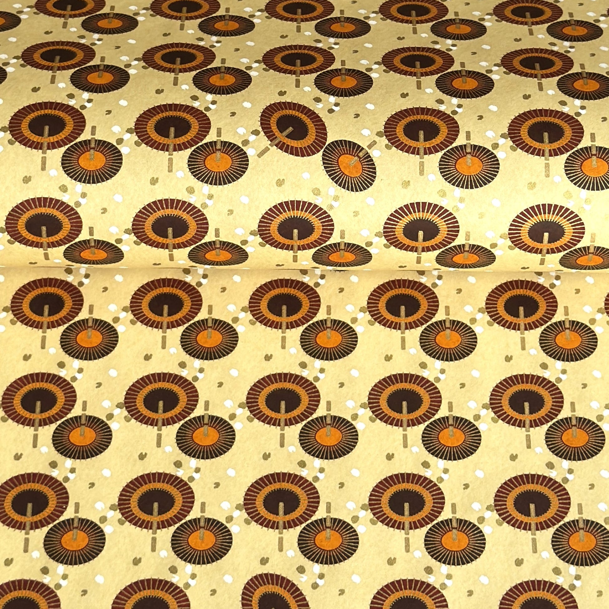 Japanese silkscreen chiyogami paper with a brown and orange umbrella pattern on a buttermilk backdrop 